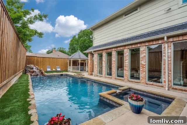 Another view of the elegant living area, emphasizing natural light and connection to the outdoor oasis.