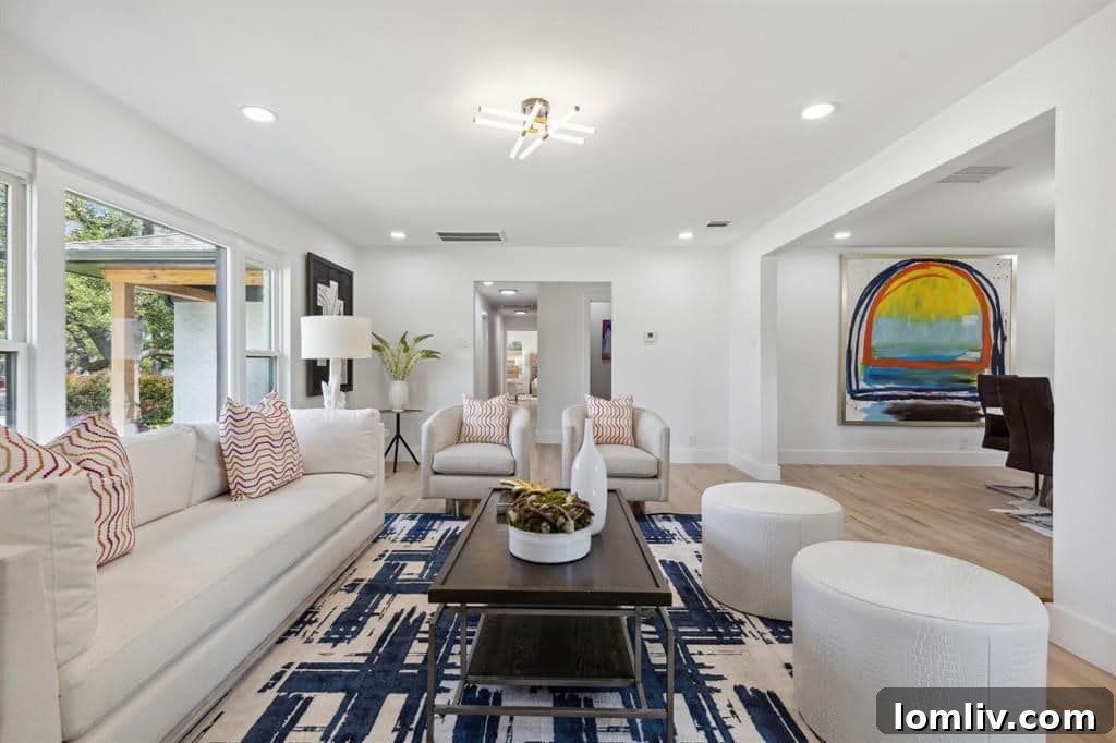 Bright formal living room with built-in shelving and large windows