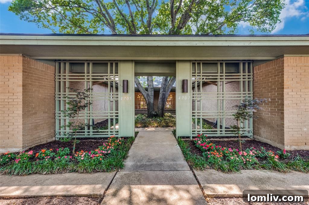 Inviting front entrance of a modern Fort Worth duplex with a well-maintained lawn and mature landscaping.