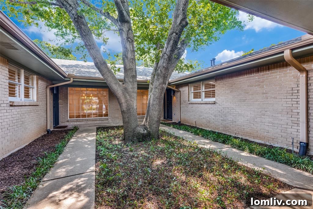 Close-up of the charming courtyard and trellised entry of the Overton Woods duplex, highlighting its Post-Midcentury aesthetic.