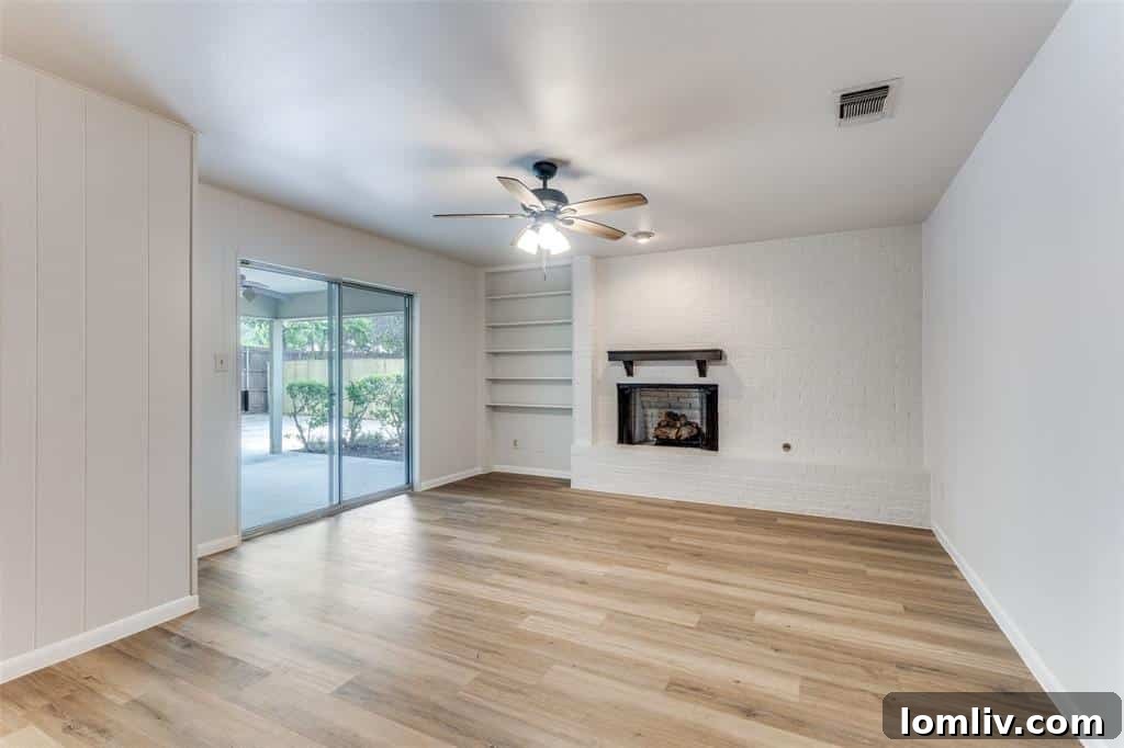 A second inviting living space with a cozy fireplace in one of the Fort Worth duplex units, ideal for relaxation.