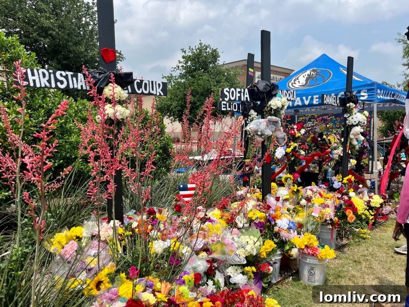 Flowers and crosses adorn a memorial erected outside the Allen Premium Outlets, where eight were killed Saturday, May 6.
