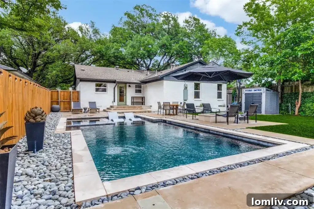 Relaxing pool area with river rocks and new concrete decking