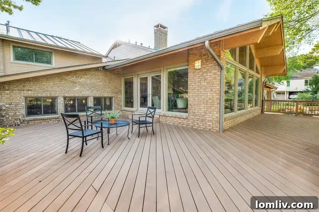 Exterior view of the home's rear, showing a patio and the expansive golf course beyond.