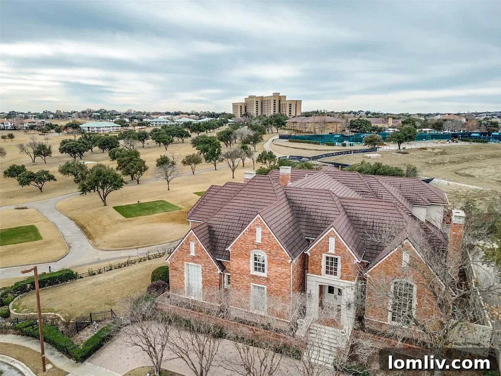 Grand traditional manor exterior with a circular driveway and elegant landscaping, hinting at luxury.