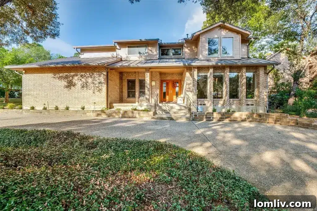 Elegant soft contemporary home exterior with manicured landscaping, overlooking a golf course.