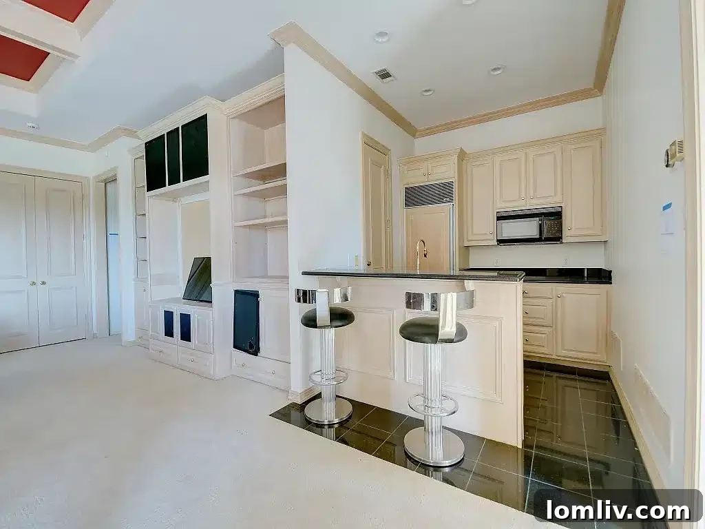 Expansive outdoor living area with a covered patio, outdoor kitchen, and views of the golf course.