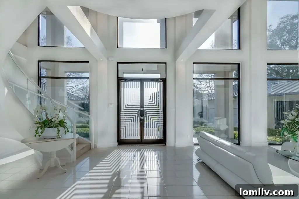 Modern home exterior with sharp angles, large windows, and a multi-level design overlooking a golf course.