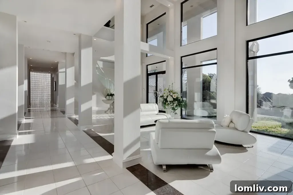 Elegant living area with soaring ceilings, a grand fireplace, and panoramic views through floor-to-ceiling windows.