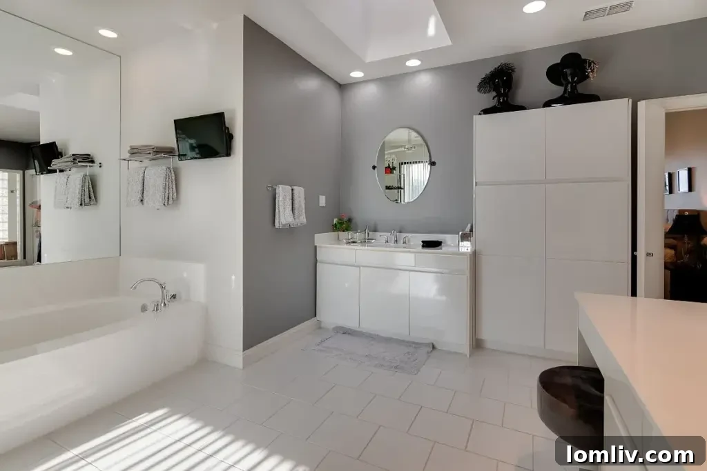 Spa-like master bathroom with a contemporary freestanding tub, elegant tiling, and abundant space.