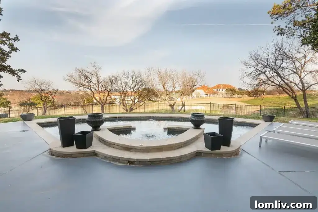 Aerial view showcasing the modern architecture of the home, its balconies, and the sprawling Cottonwood Valley Golf Course.