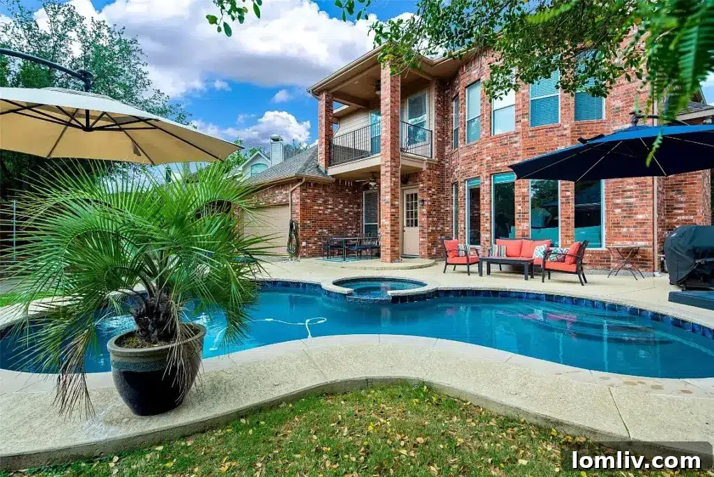 Modern swimming pool and expansive deck at 4416 Mira Vista Drive in Frisco, showcasing recent updates and readiness for summer entertaining.