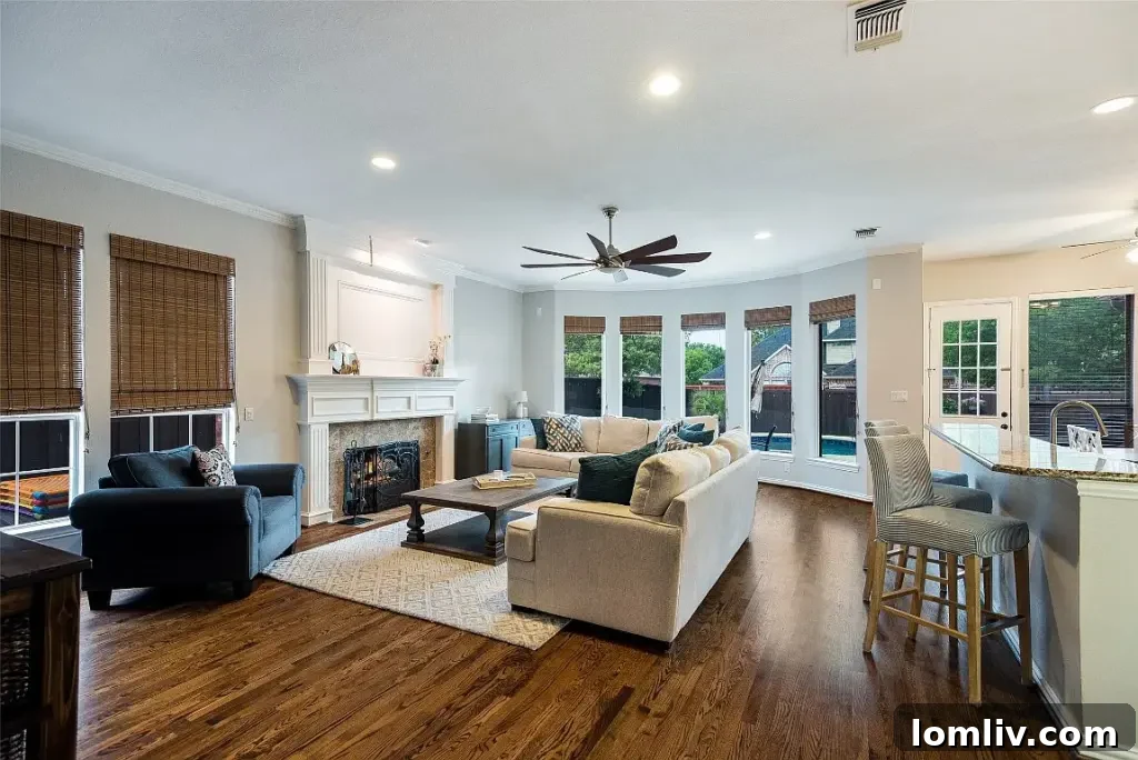 Open-concept living room flowing into a modern kitchen with dual islands at 4416 Mira Vista Drive, Frisco, perfect for entertaining and family life.