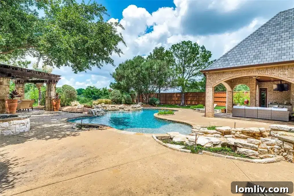 Expansive outdoor living area at 5204 Pool Road, Colleyville, featuring a multi-level swimming pool, ample dining space, and a covered patio for entertaining.