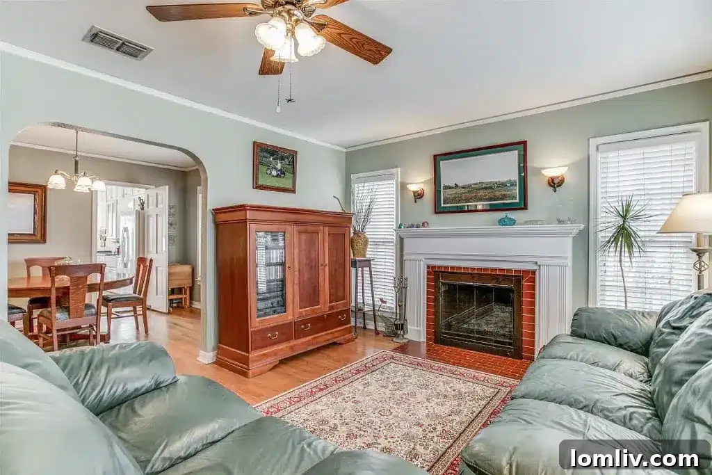 Cozy living room interior of the Dallas home at 2610 Marvin Avenue, featuring a traditional fireplace and hardwood floors, adding warmth and character.