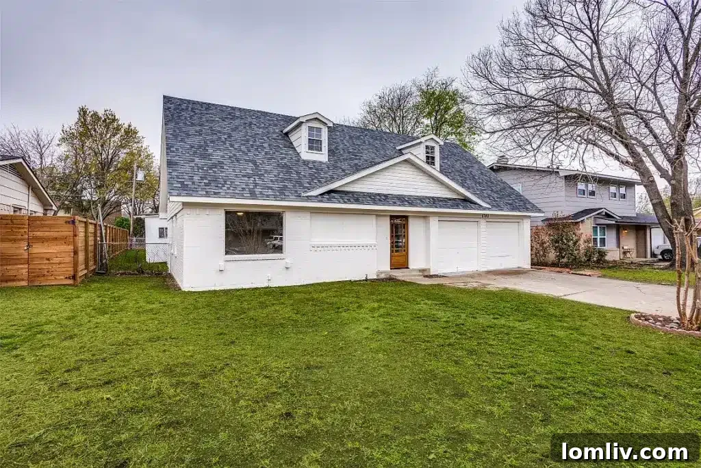 Charming white exterior of 8740 Charing Cross Lane, featuring a classic high-pitched roof and manicured landscaping, inviting families to East Dallas.