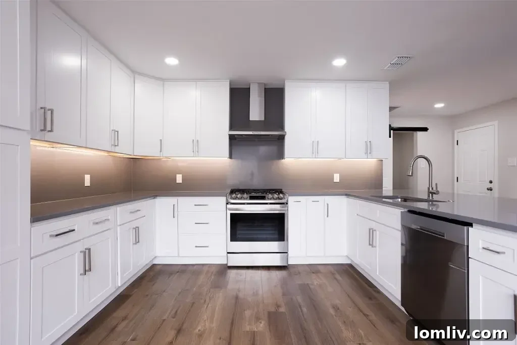 Modern kitchen with high-end finishes and stainless steel appliances at 8740 Charing Cross Lane.