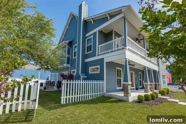 A charming cadet blue Craftsman home with a white picket fence, enhancing its curb appeal in McKinney.