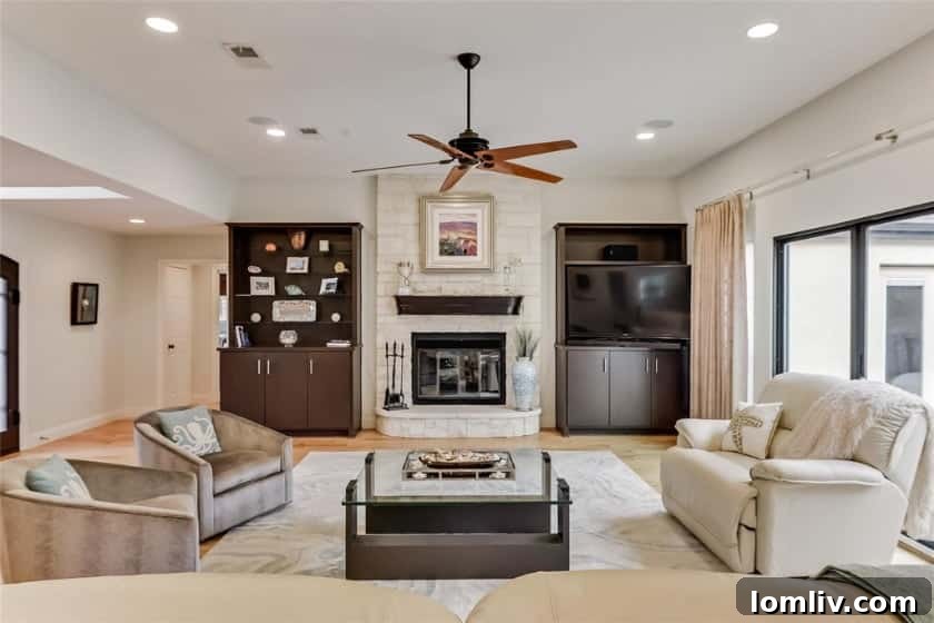 Gourmet kitchen with subtle marble countertops opening to living room
