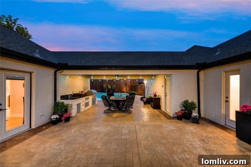 Expansive backyard with covered outdoor kitchen, dining, and fire feature