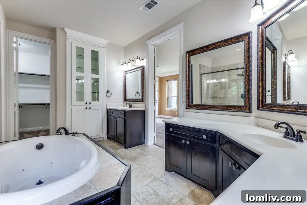Luxurious master bathroom with dual vanities, modern finishes, and a spacious shower