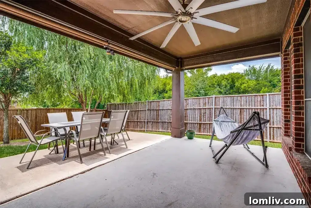 Covered patio offering outdoor relaxation space and shade in a Wylie backyard