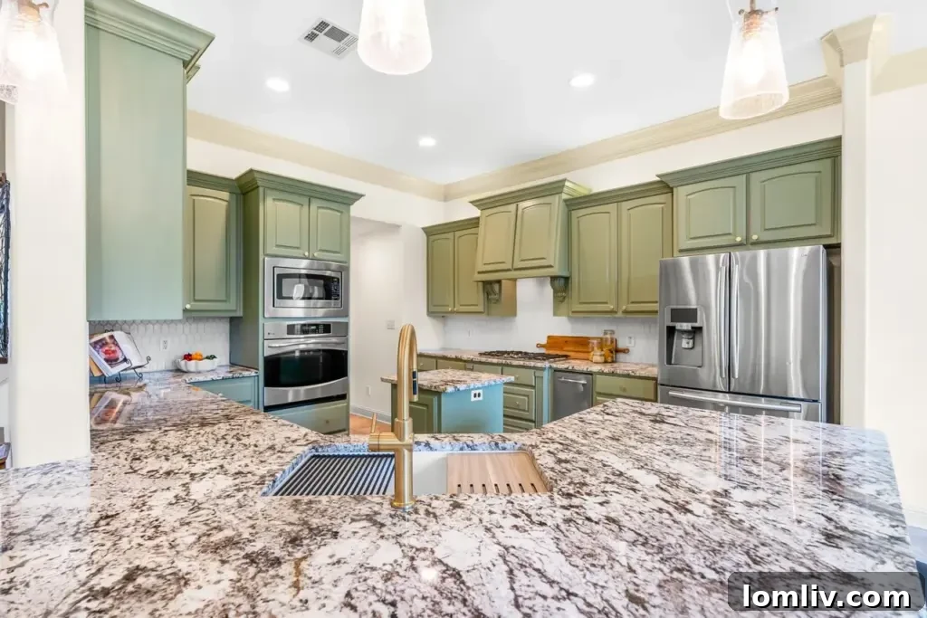 Renovated kitchen with olive sage cabinets and granite countertops