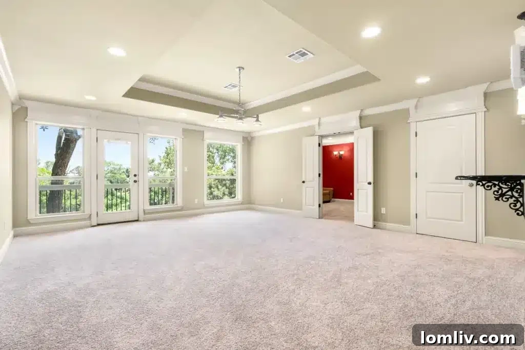 Spacious primary bedroom with French doors to patio
