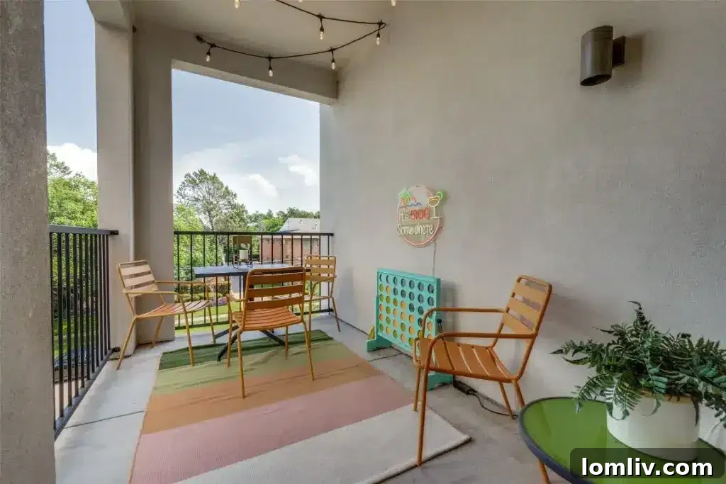 Inviting covered balcony of the M Streets condo, complete with outdoor seating and beautiful views of the tree-lined neighborhood.