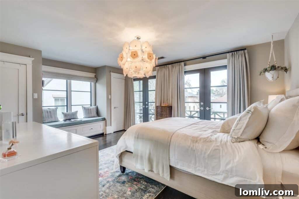 Spacious and serene primary bedroom suite with high vaulted ceilings, large windows, and luxurious finishes