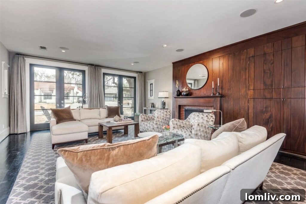 Elegant home office with floor-to-ceiling custom built-in bookshelves and ample natural light