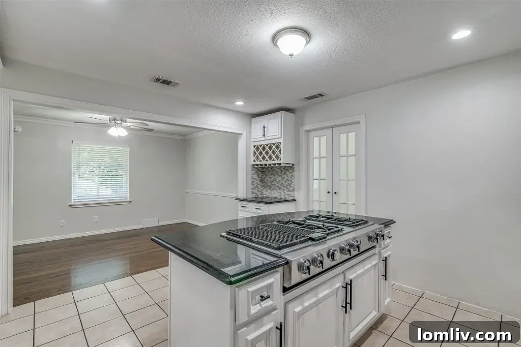Spacious dining room leading into the living area of the renovated home