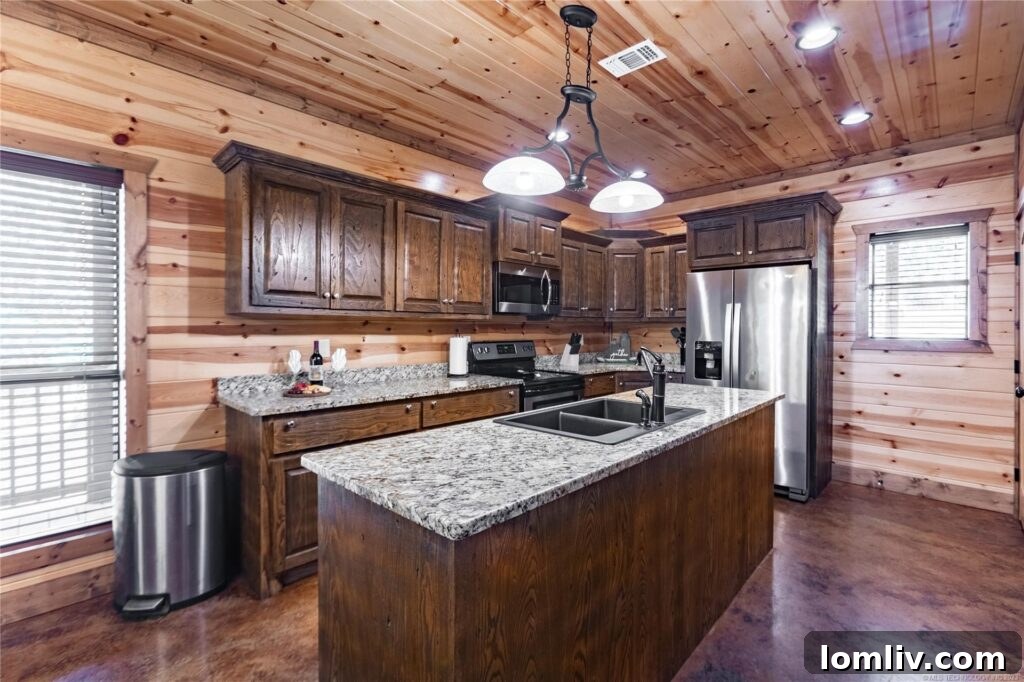 Spacious game room inside a luxury cabin with arcade games, a pool table, and comfortable seating, perfect for family entertainment