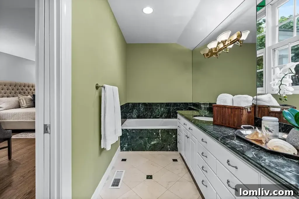 Elegant ensuite bathroom with dual vanities and beautiful marble finishes.