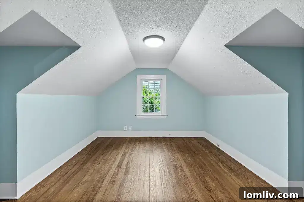 Uniquely designed secondary bedroom with dormer windows and charming architecture.