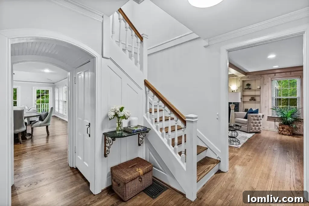 Elegant interior hallway with sophisticated molding and wainscoting.
