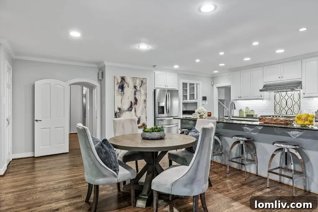 Spacious, sleek kitchen with stainless steel appliances and an oversized eat-in island.