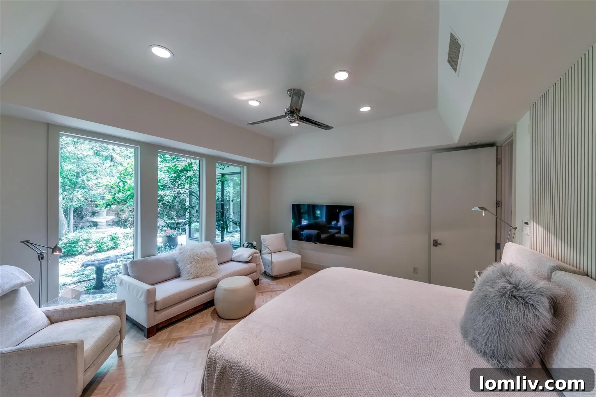 Bedroom featuring oversized windows and a scenic backyard view