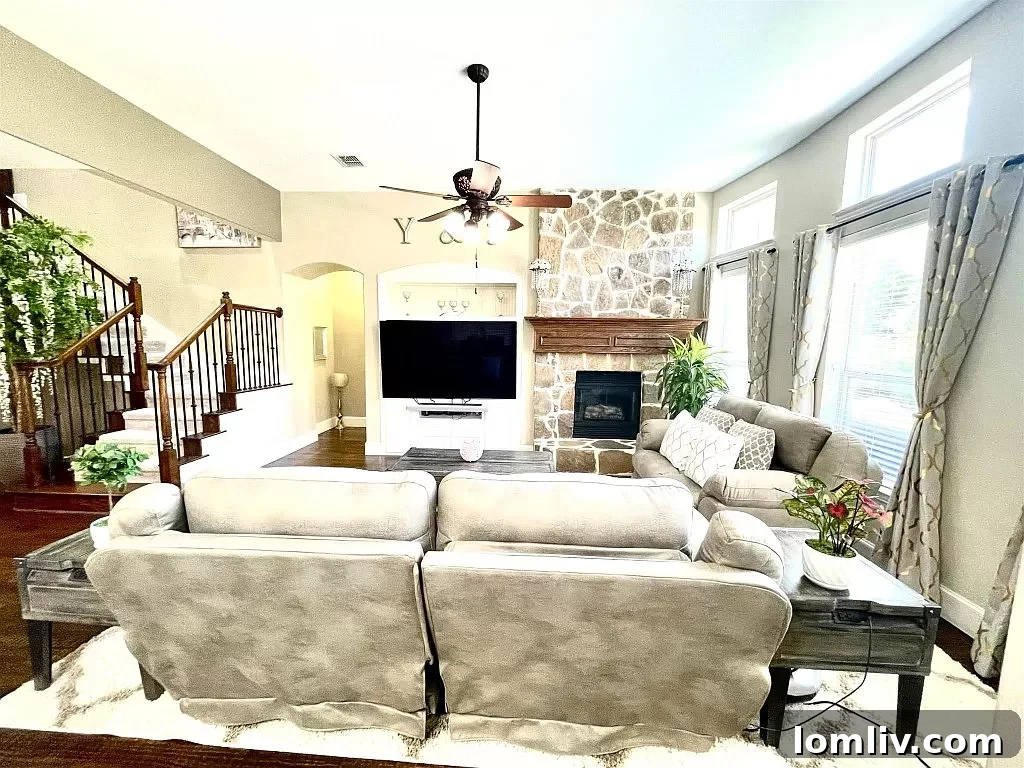 Living room with fireplace and picturesque backyard view
