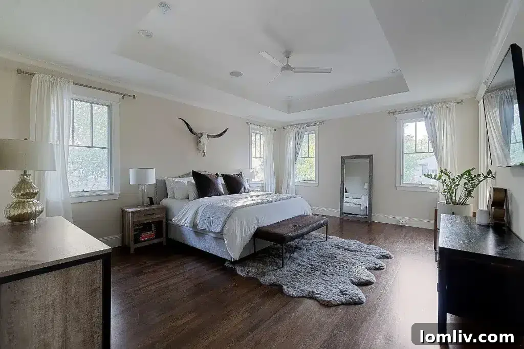 Spacious and elegantly designed primary bedroom with ample natural light