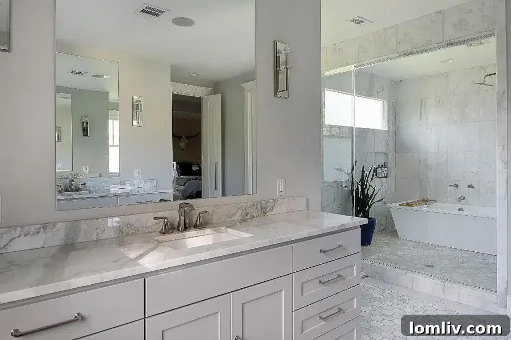 Luxurious ensuite bathroom with a marble wet room, dual vanities, and intricate tilework