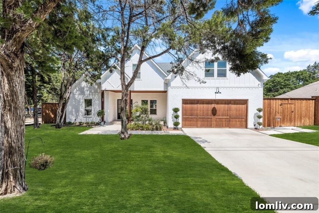 Cool Down: Your Next Home Awaits 16 The inviting modern farmhouse exterior of 5106 Cliff Haven Drive, showcasing a blend of traditional and contemporary elements, surrounded by lush greenery.