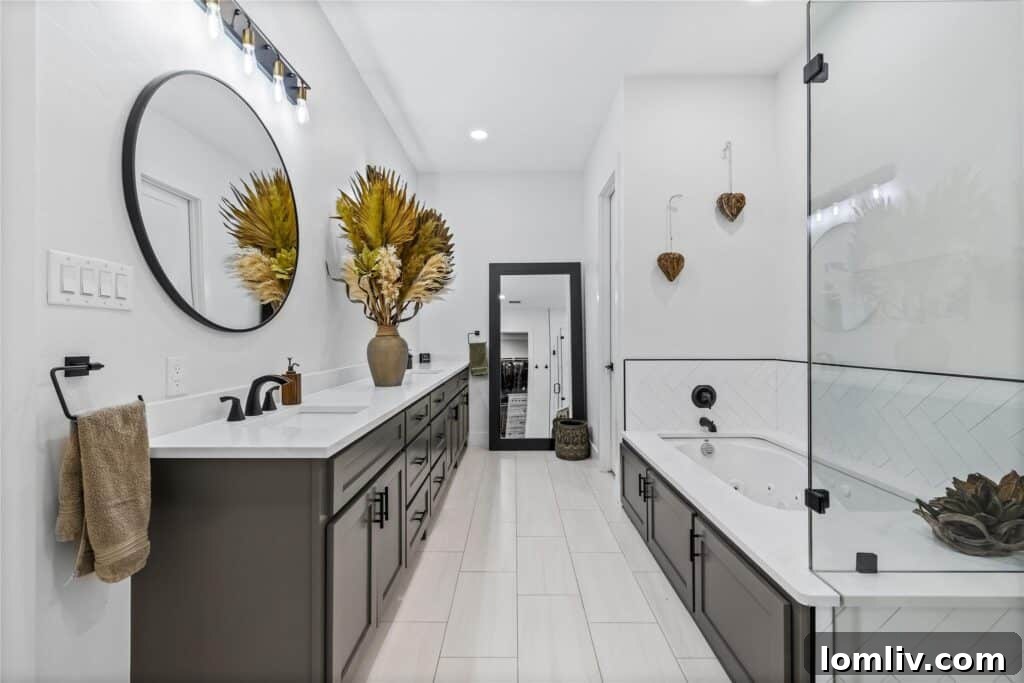 Cool Down: Your Next Home Awaits 18 The luxurious master bathroom of 5106 Cliff Haven Drive, featuring high-end fixtures, a freestanding tub, and a spacious shower, creating a spa-like experience.
