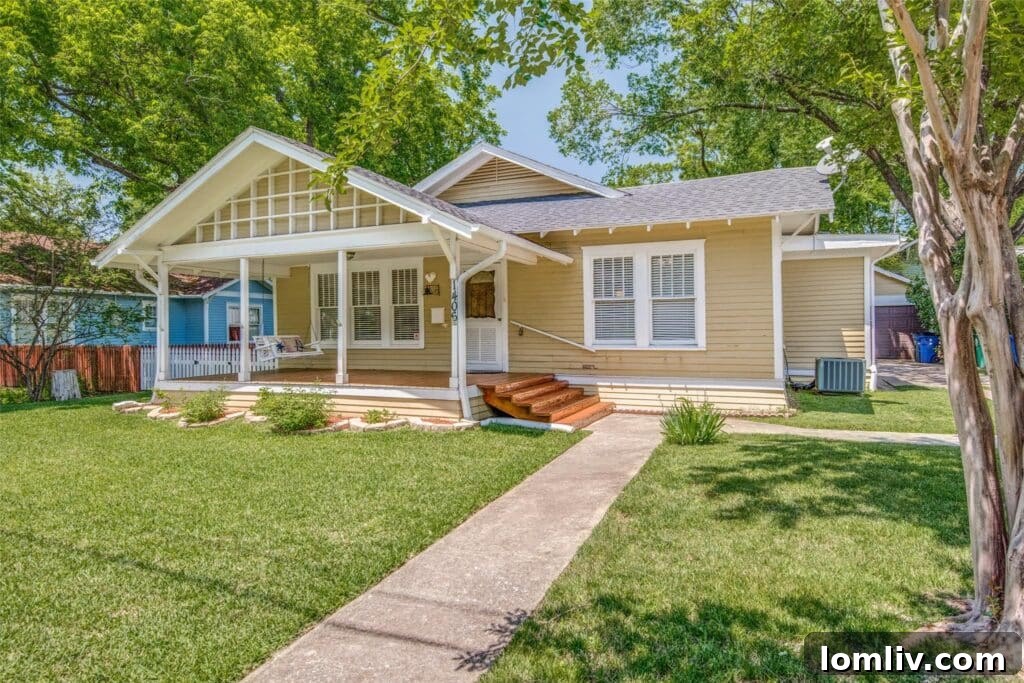 A charming 1925 daisy yellow cottage on W. Louisiana Street in Historic Downtown McKinney, featuring a white picket fence.