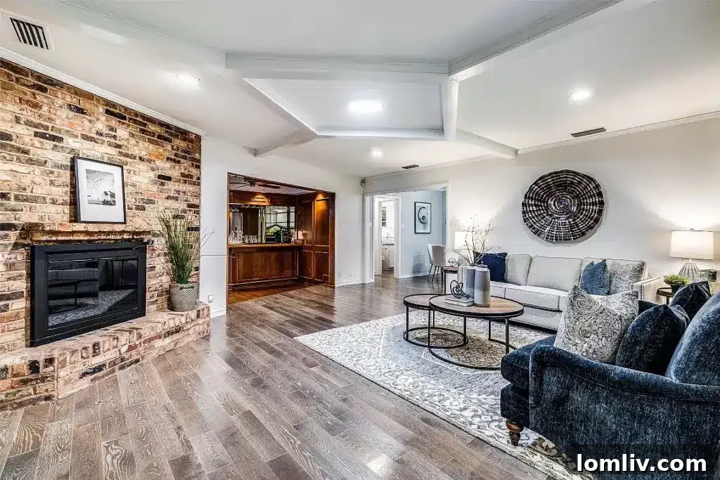 Comfortable family room featuring a beautiful brick fireplace, ample seating, and natural light