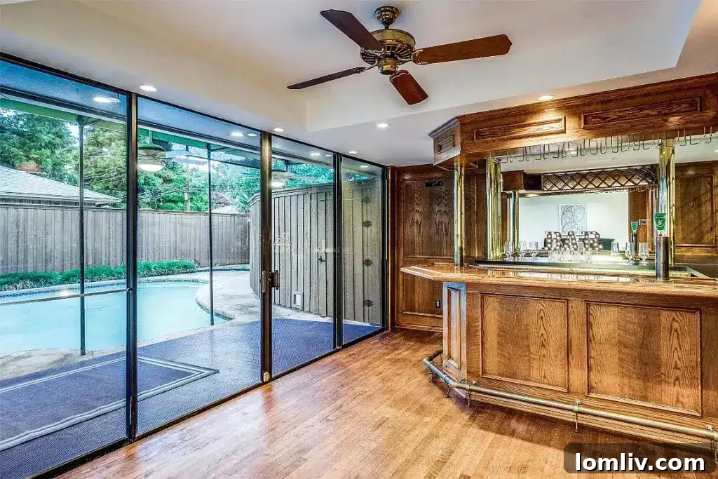 View of the family room leading to the wet bar, showing seamless flow between entertaining spaces