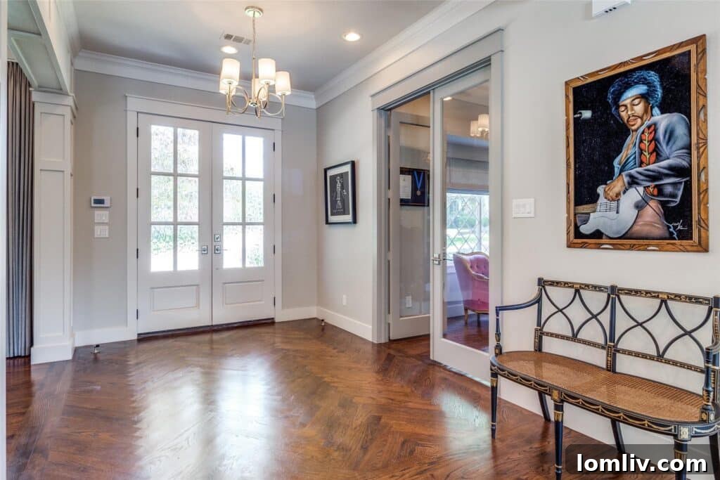 Inviting front foyer with rich chevron hardwood floors