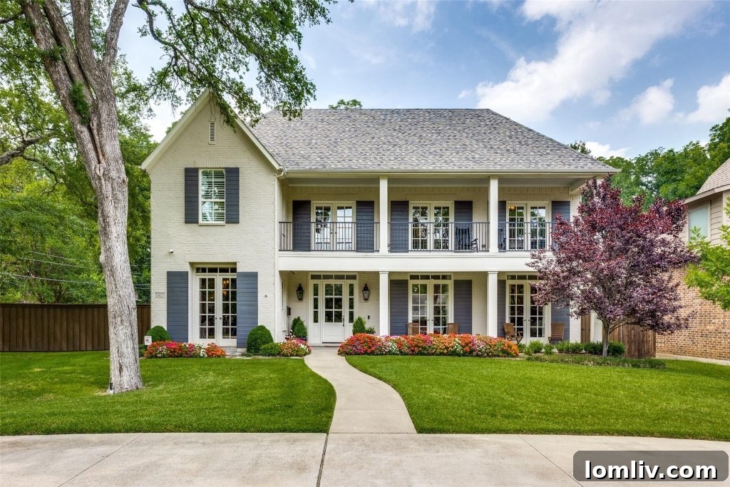 Elegant transitional home exterior with lush landscaping