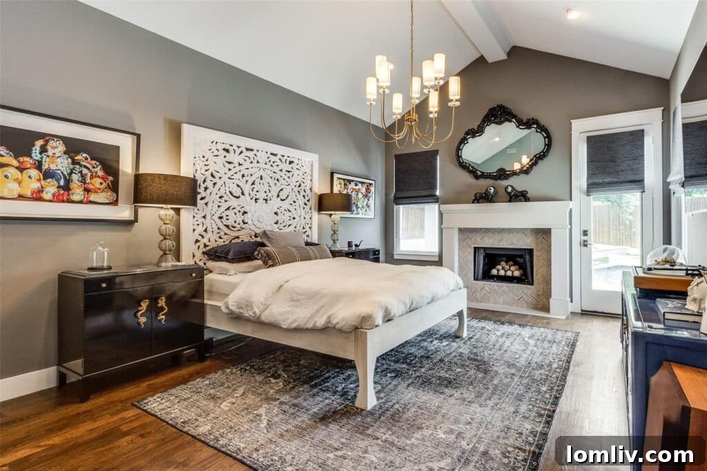 Elegant primary bedroom with vaulted ceiling and fireplace