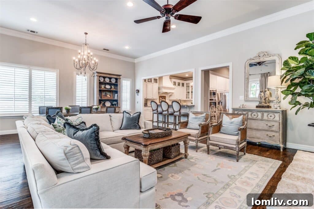Bright living room with high ceilings, fireplace, and backyard views